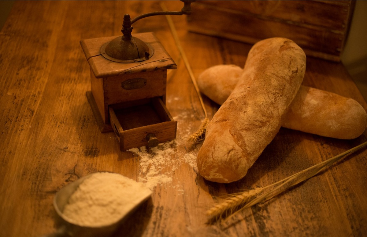 Artisan bread with flour and vintage grinder at Apulia