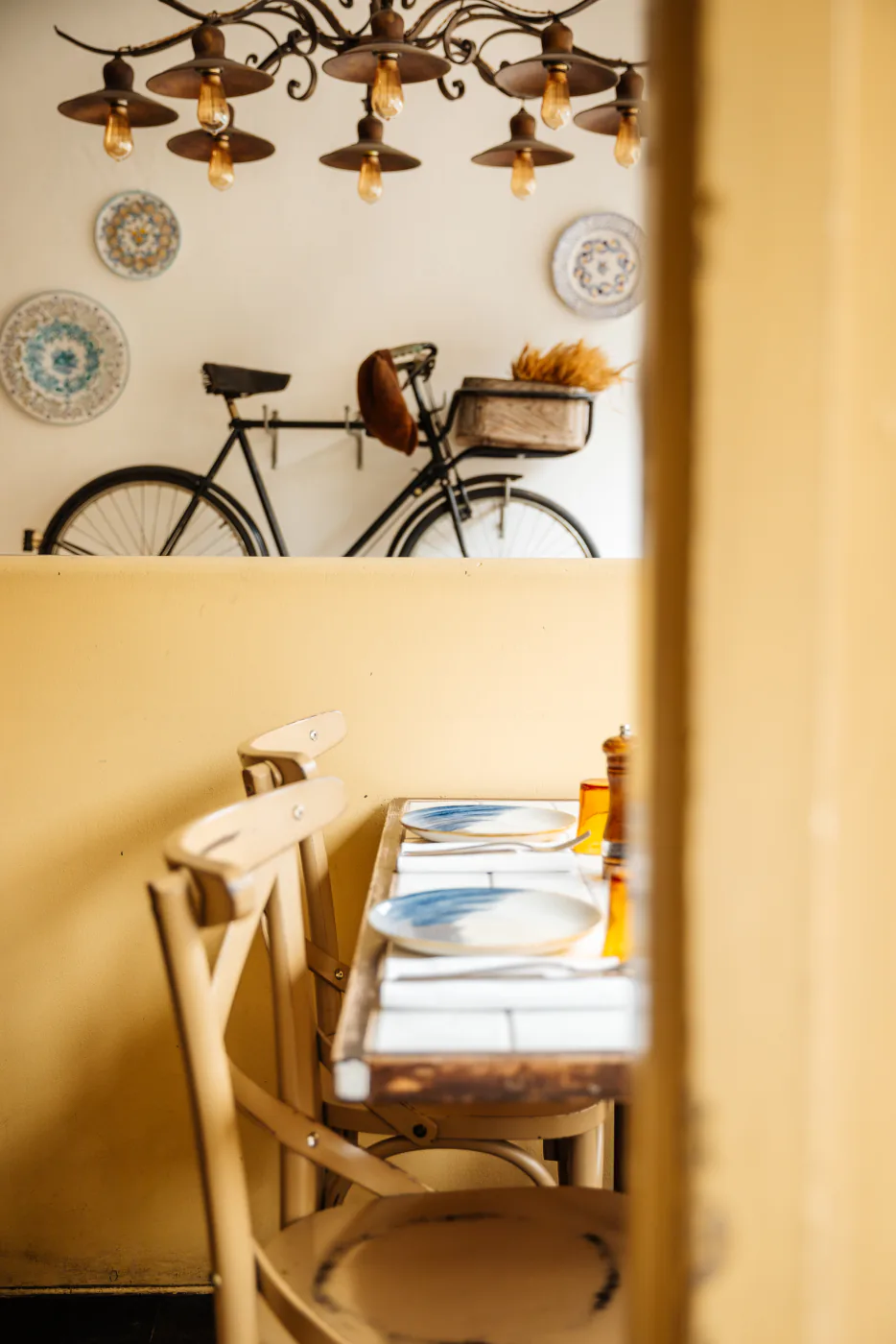 Table set for dinner with a vintage bicycle on the wall