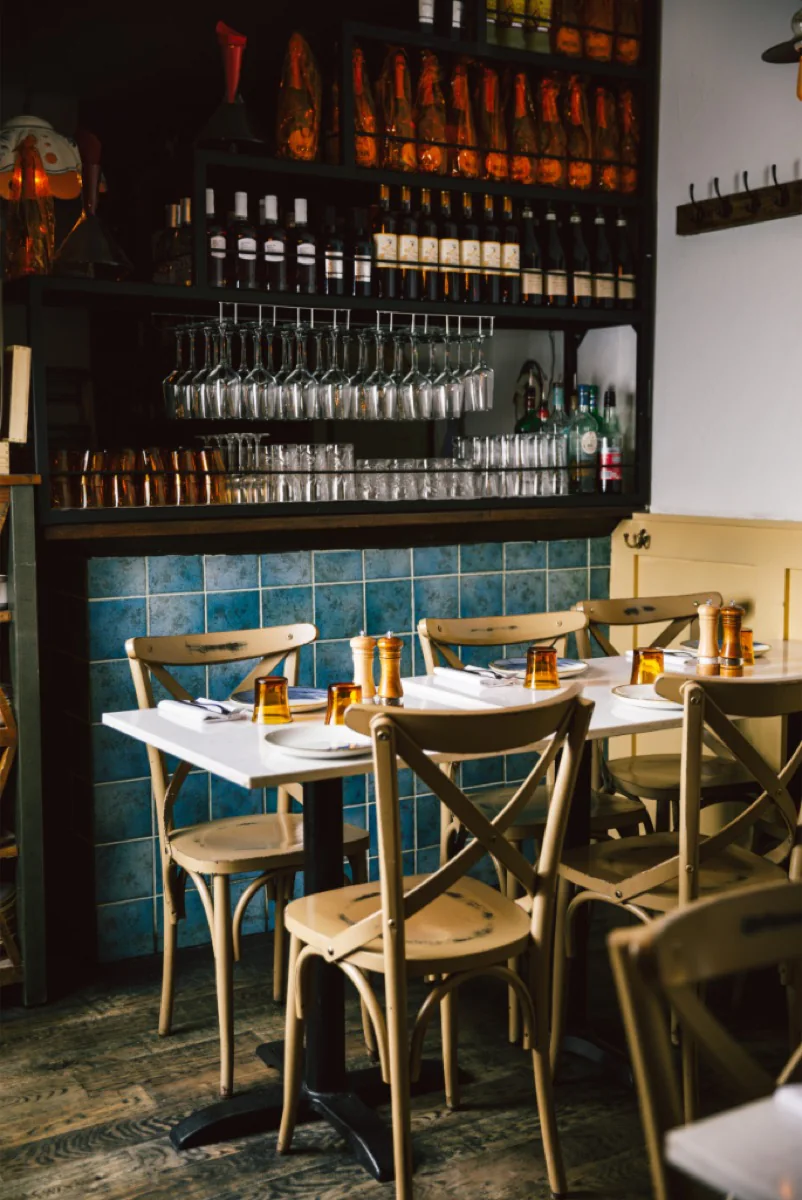 Dining room with blue tiled wall and bentwood chairs